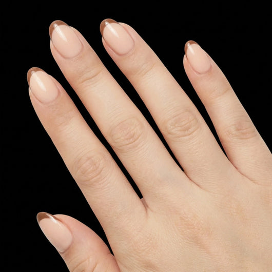Short Oval in Nude French Tip press-on nails on light skin tone - Cafe au Lait Instant Manicure.