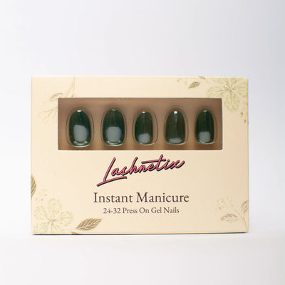 A box of Lashnetix 'Instant Manicure' press-on nails against a white background. The packaging is cream-colored with gold floral sketches and displays short oval green through a clear window.