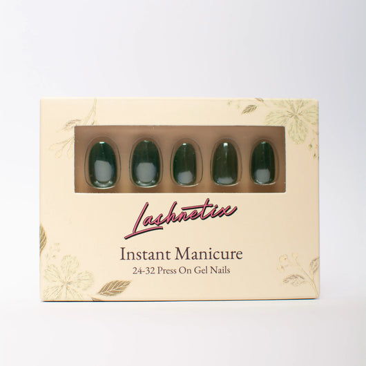 A box of Lashnetix 'Instant Manicure' press-on nails against a white background. The packaging is cream-colored with gold floral sketches and displays short oval green through a clear window.
