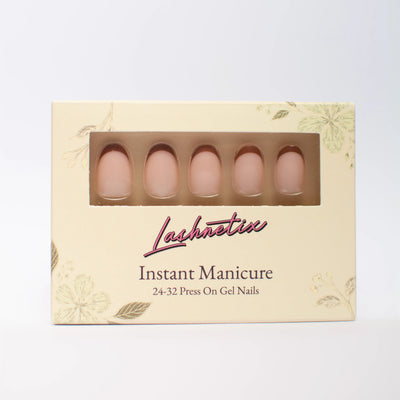 A box of Lashnetix 'Instant Manicure' press-on nails against a white background. The packaging is cream-colored with gold floral sketches and displays short oval nude french tip through a clear window.