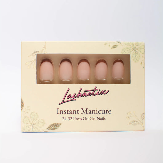 A box of Lashnetix 'Instant Manicure' press-on nails against a white background. The packaging is cream-colored with gold floral sketches and displays short oval nude french tip through a clear window.