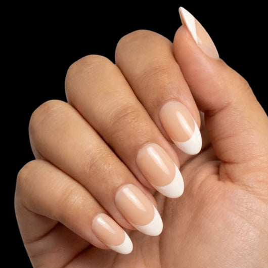 Soft French press-on nail set - short oval nails with sheer pink base and white French tips, dorsal view