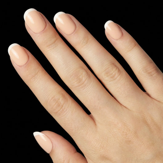 Short Squoval in Nude French Tip press-on nails on light skin tone - Petite French Instant Manicure.
