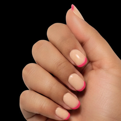 Pink Pop press-on nail set - extra-short squoval nails with nude base and hot pink French tips, dorsal view