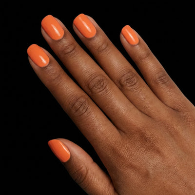 Short Squoval in Orange press-on nails on deep skin tone - Sunset Orange Instant Manicure.