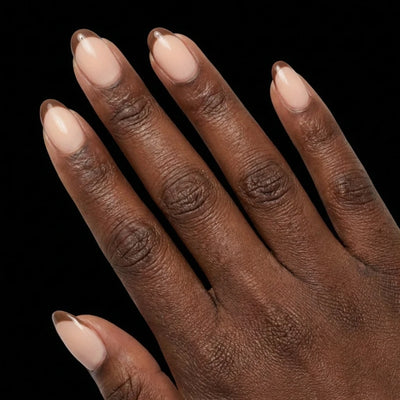 Short Oval in Nude French Tip press-on nails on deep skin tone - Cafe au Lait Instant Manicure.