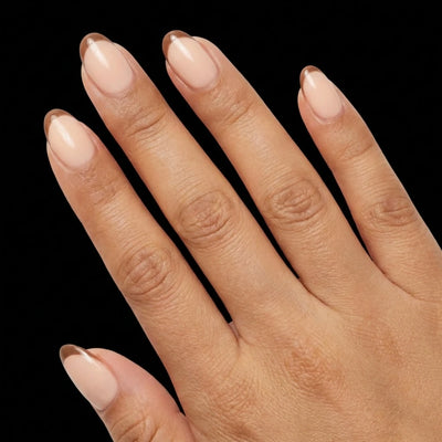 Short Oval in Nude French Tip press-on nails on medium skin tone - Cafe au Lait Instant Manicure.