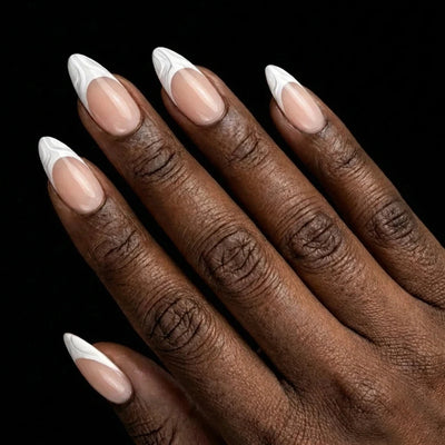 Short Almond in Nude French Tip press-on nails on deep skin tone - French Kiss Instant Manicure.