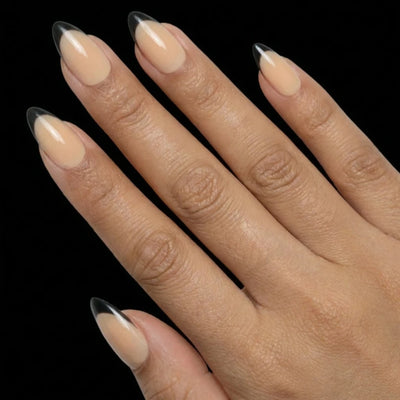 Short Almond in Nude French Tip press-on nails on medium skin tone - French Noir Instant Manicure.