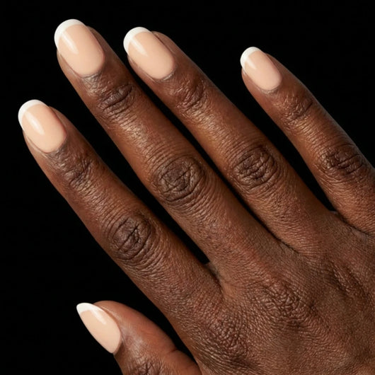 Short Squoval in Nude French Tip press-on nails on deep skin tone - Petite French Instant Manicure.
