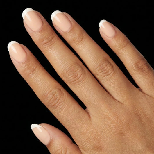 Short Squoval in Nude French Tip press-on nails on medium skin tone - Petite French Instant Manicure.