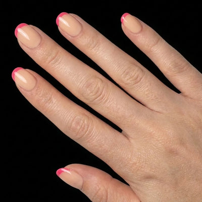 Short Squoval in Pink French Tip press-on nails on light skin tone - Pink Pop Instant Manicure.