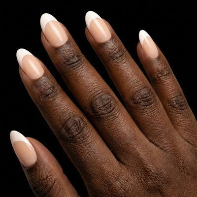 Short Oval in Nude French Tip press-on nails on deep skin tone - Soft French Instant Manicure.