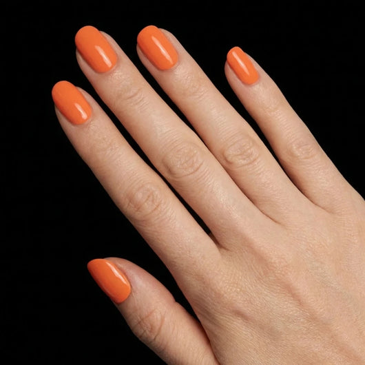 Short Squoval in Orange press-on nails on light skin tone - Sunset Orange Instant Manicure.