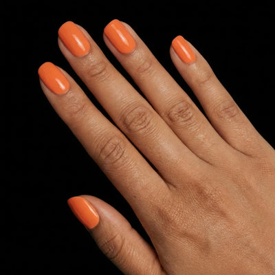 Short Squoval in Orange press-on nails on medium skin tone - Sunset Orange Instant Manicure.