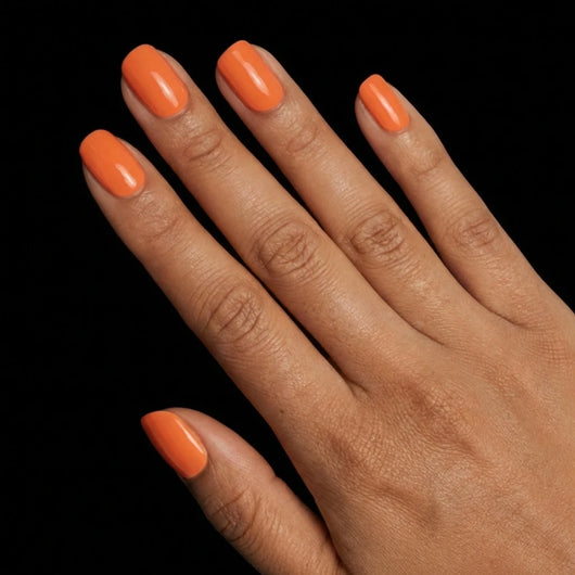 Short Squoval in Orange press-on nails on medium skin tone - Sunset Orange Instant Manicure.