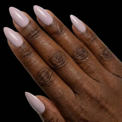 Short Almond in Lavender press-on nails on deep skin tone - Sweet Wisteria Instant Manicure.